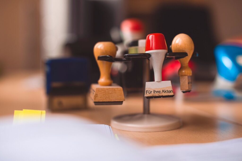 Rubber stamps on a stand on a wooden office desk